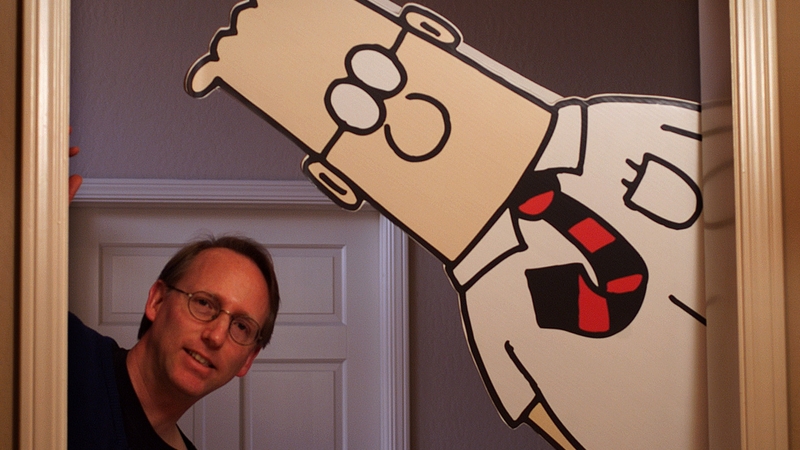 Scott Adams pictured with his cartoon character (file image)