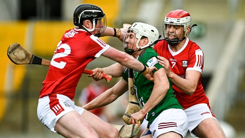 Joseph Boyle of Westmeath is tackled by Conor Cahalane (L) and Dáire O'Leary
