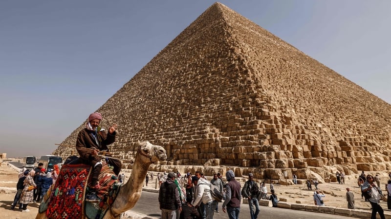 Tourists visit the Great Pyramid of Khufu (Cheops) at the Giza Pyramids in Egypt today