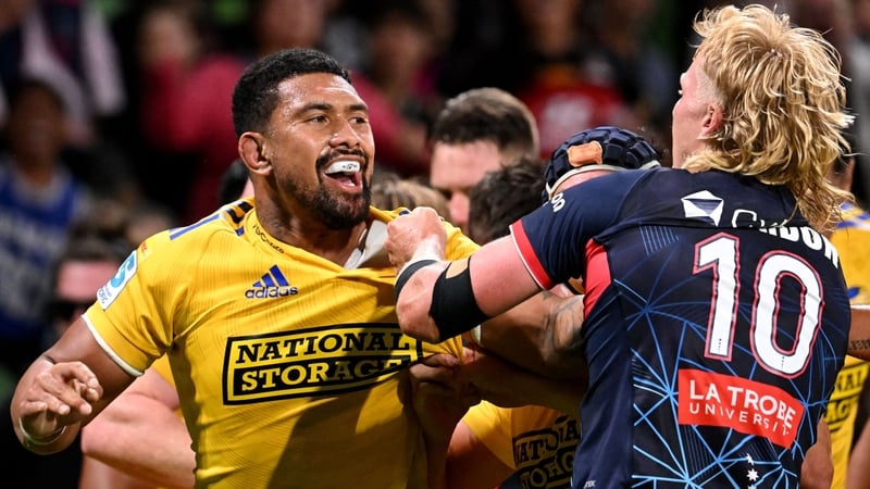 Hurricanes captain Ardie Savea (l) fights with Rebels' Aidan Morgan