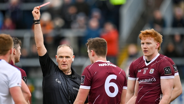 Referee Conor Lane shows a red card to Peter Cooke