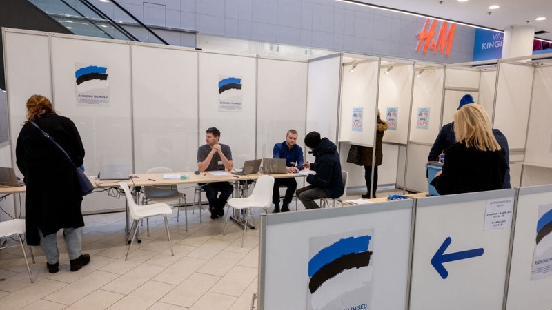 People cast their vote in a polling station at a shopping centre in Tallinn, Estonia
