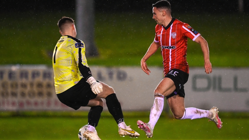Jordan McEneff of Derry City goes past UCD goalkeeper Lorcan Healy on his way to scoring his side's second goal