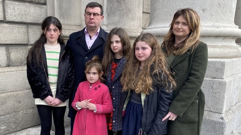 Rebecca and Tom Collins, with their four other daughters, outside the court today