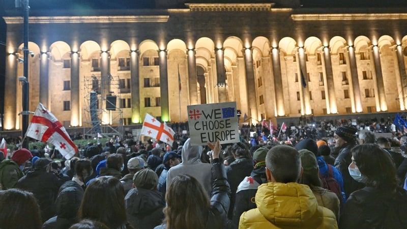 Waving Georgian, Ukrainian and EU flags, protesters gathered outside the parliament building in the capital Tbilisi