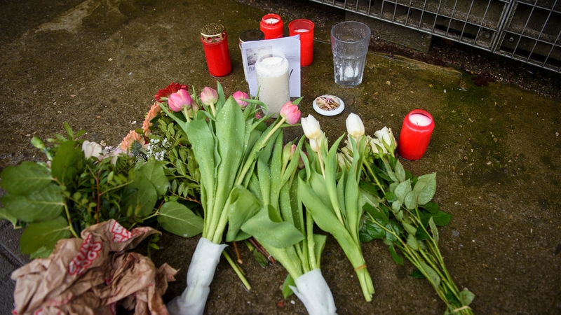 Flowers and candles are left outside the building where the attack occurred
