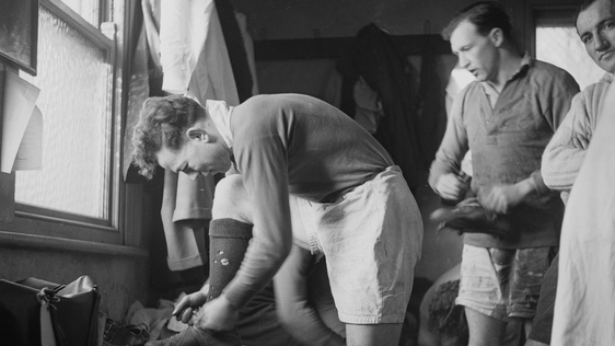17th March 1951: Irish rugby player Karl Mullen tying his boot laces in the changing room. Original…