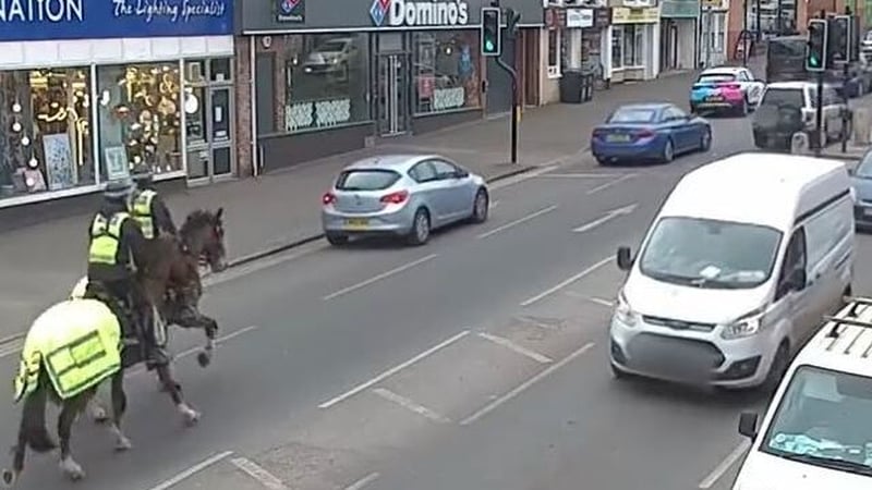 Officers gave chase after spotting the man using his phone while driving the silver car (centre)