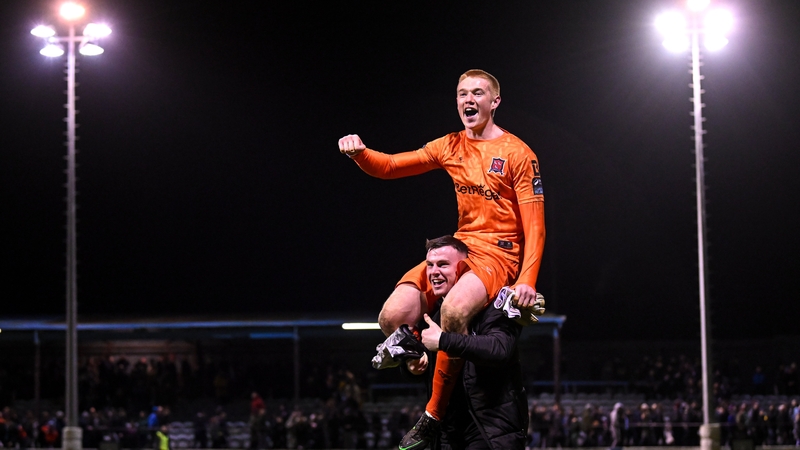 Dundalk goalkeeper Nathan Shepperd is lifted by team-mate Mark Byrne