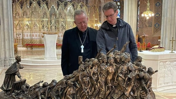 Eamon Martin and Fr Bill Kemmy at the sculpture in Armagh Cathedral