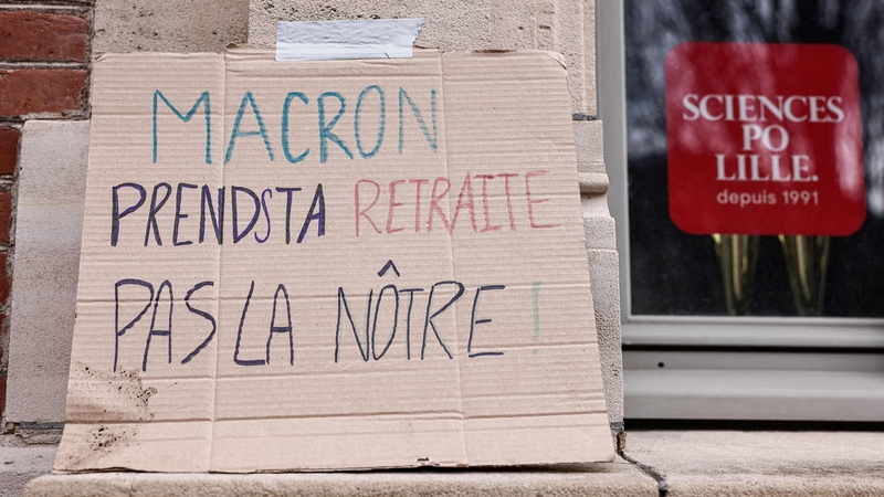 A placard reading 'Macron, go for your retirement, not ours' is seen outside the Institute of Political Studies in Lille