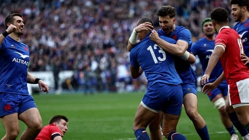 Gael Fickou (13) is congratulated after scoring France's fourth try