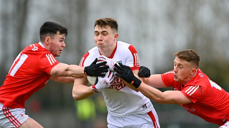 Luke Fahy of Cork tackled by Louth's Liam Jackson, left, and Ryan Burns