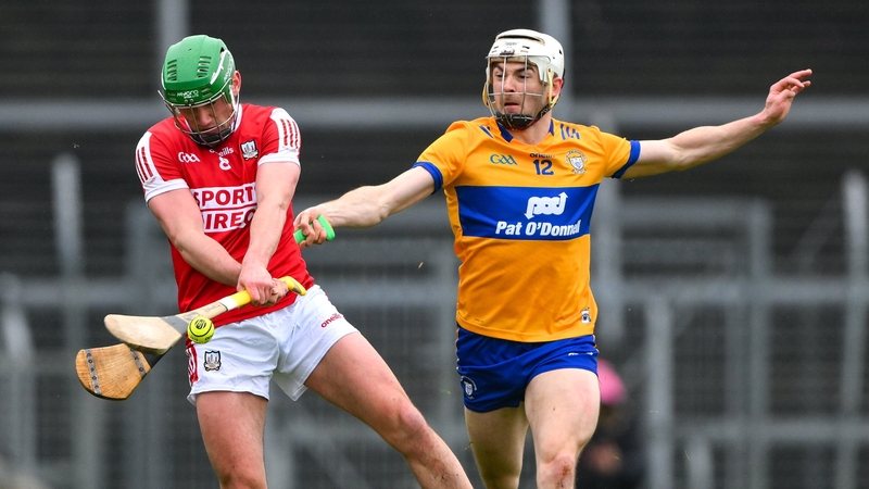 Brian Roche of Cork is tackled by Ryan Taylor of Clare
