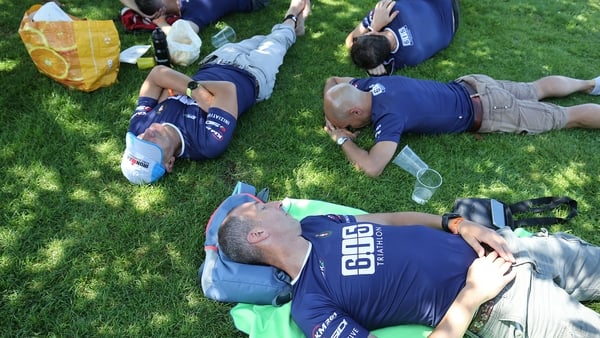 Ironman competitors take a nap before the start of a race in Switzerland