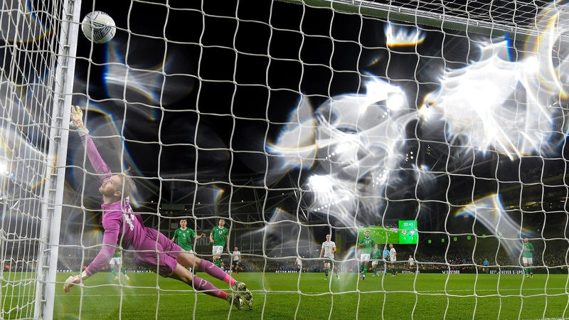 Caoimhin Kelleher attempts to get to the shot which resulted in Latvia's first goal