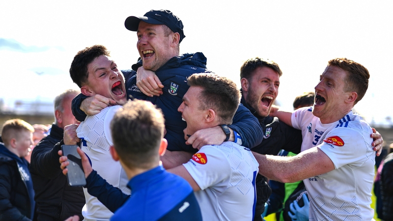 Monaghan players celebrate with manager Vinny Corey after avoiding relegation on the final day once again