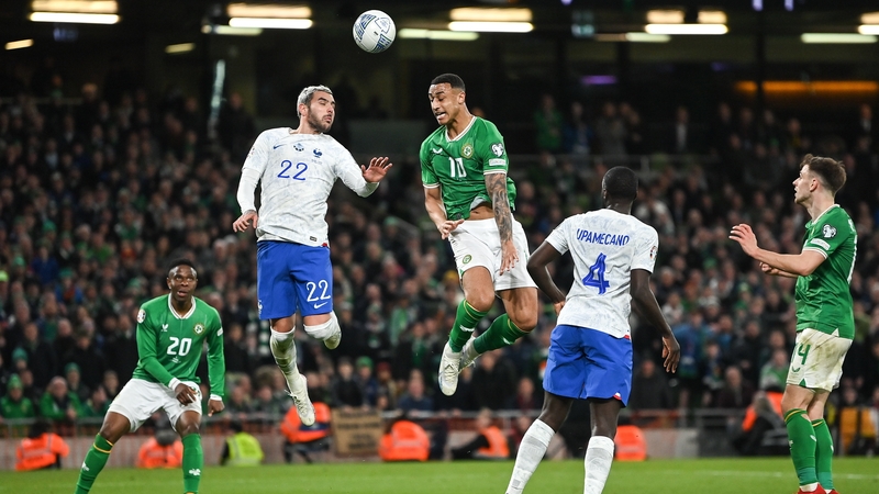 Adam Idah and Theo Hernandez compete for the ball during the Lansdowne Road encounter