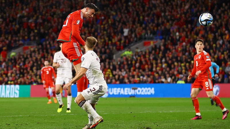 Kieffer Moore scores with a trademark header for Wales