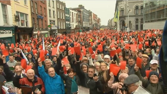 Anti-property tax campaigners wave red cards outside Dublin Castle, 2013.