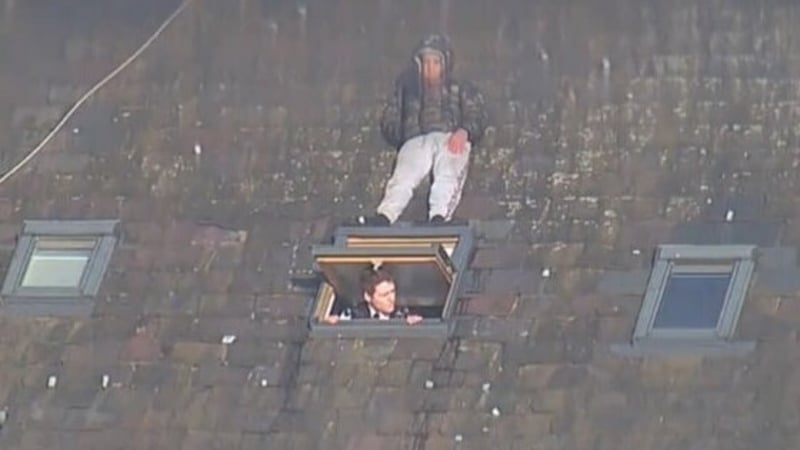 Etmond Lika is seen just inches away from a searching police officer on the rood of a building (Image: Crown Prosecution Service)