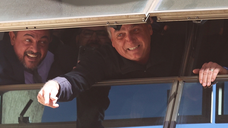 Jair Bolsonaro greets supporters on his return to Brasilia