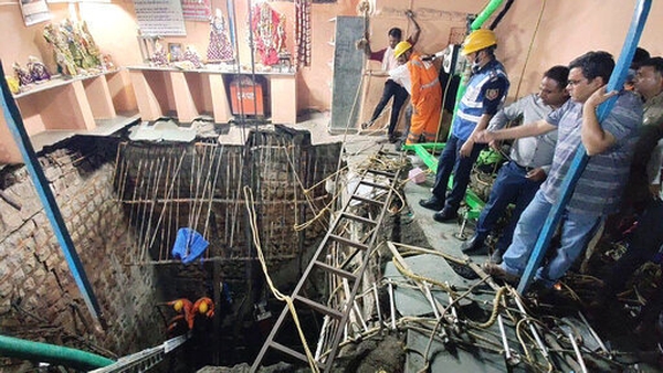 Rescuers work at the site of a floor cave-in inside a temple in Indore, Madhya Pradesh state, India