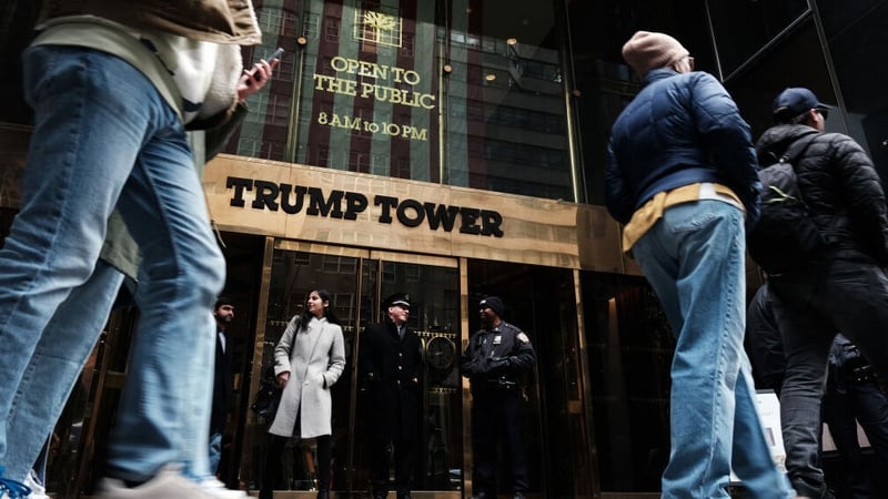 People walk by Trump Tower the morning after former president Donald Trump was indicted by a New York jury