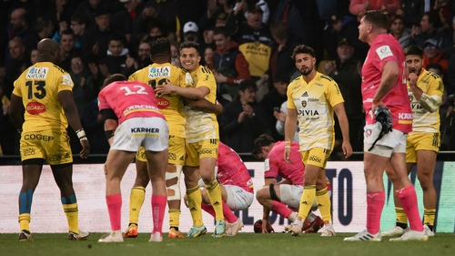 La Rochelle's French fly-half Antoine Hastoy (3th R) celebrates with team-mates at full-time