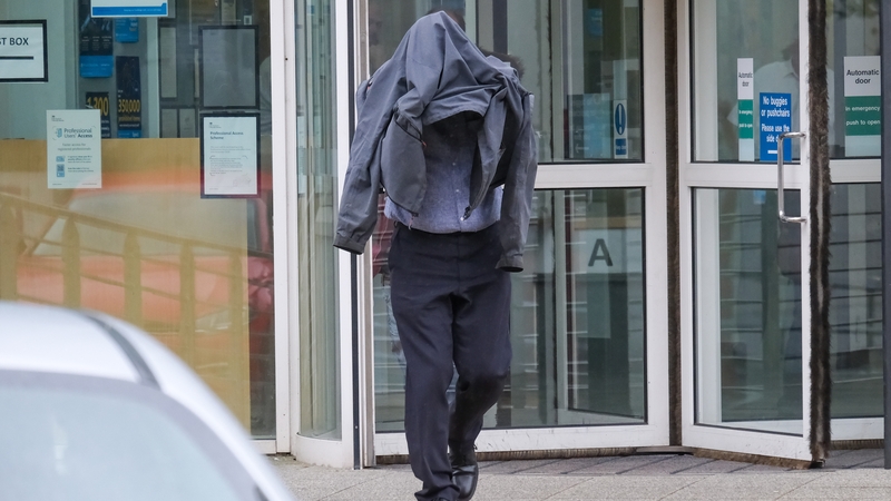 Timothy Schofield covering his head as he leaves Exeter Crown Court