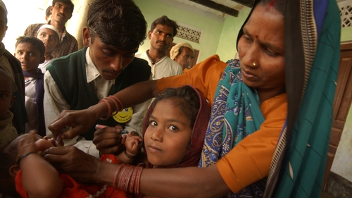 A child receives a polio vaccine at a clinic set up by the World Health Organization in India in 2003