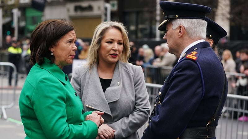 Mary Lou McDonald and Michelle O'Neill speaking with a senior member of An Garda Síochána outside the GPO today