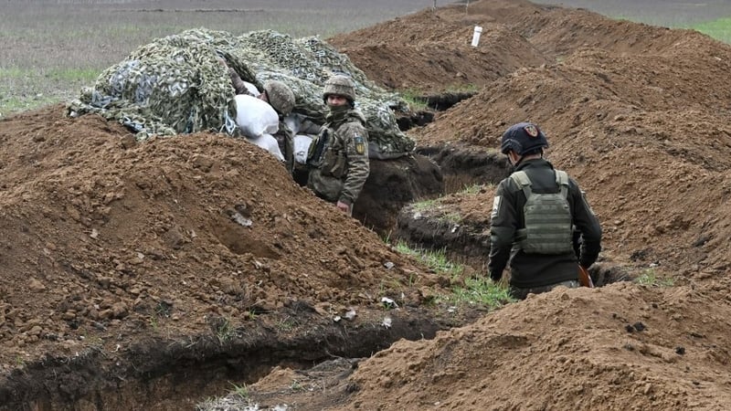 Ukrainian servicemen stand in trenches near Bakhmut