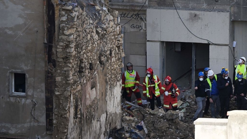 Emergency services stand among the rubble in Marseille
