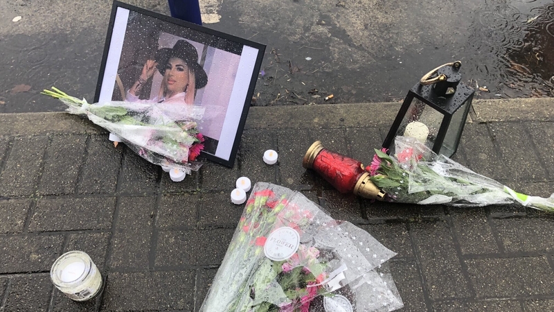 People left flowers beside candles at Steamboat Quay and stood for a minute of silence in remembrance