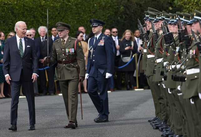 US President Joe Biden inspects a guard of honor at Cathal Brugha Barracks