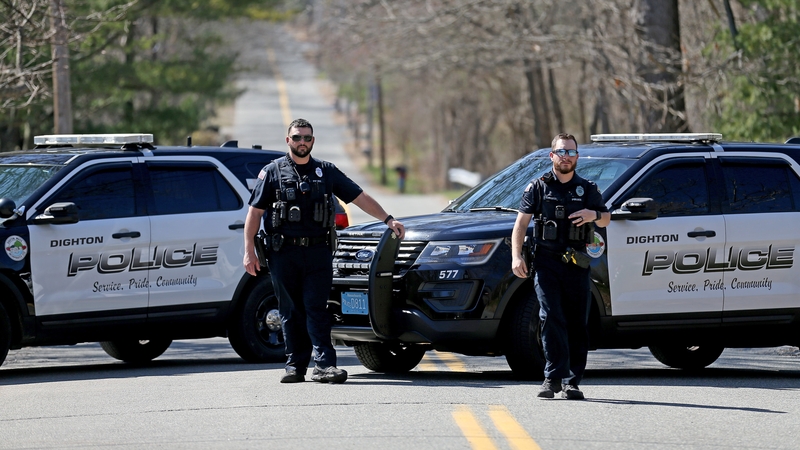 Police block a street as the FBI investigate the home of a man in connection with the of leaking classified documents