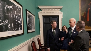 Joe Biden looking at a photograph of President John F Kennedy making his address in Leinster House in 1963, before addressing the Oireachtas