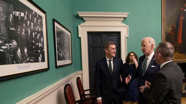 Joe Biden looking at a photograph of President John F Kennedy making his address in Leinster House in 1963, before addressing the Oireachtas
