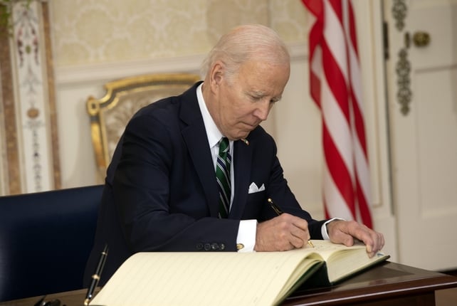 President Biden signs the visitors' book at a ceremony in the State reception room, quoting an Irish proverb 'your feet will bring you where your heart is'