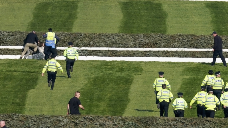 A number of protesters breached security fences around Aintree and ran on to the course