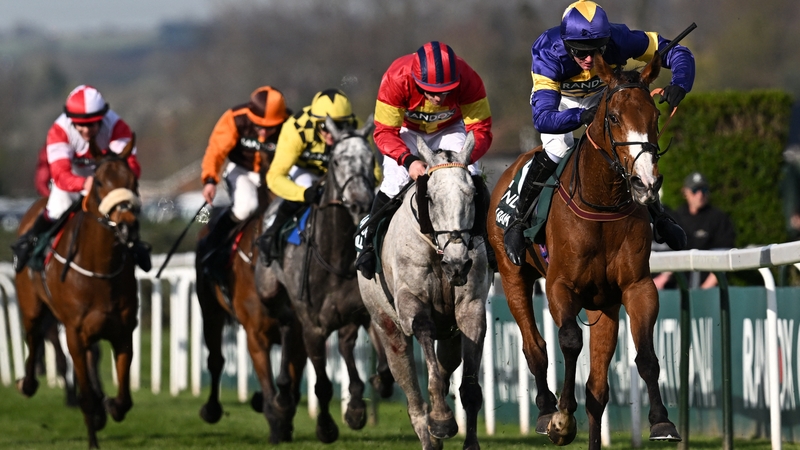 Jockey Derek Fox rides Corach Rambler (R) on the run-in