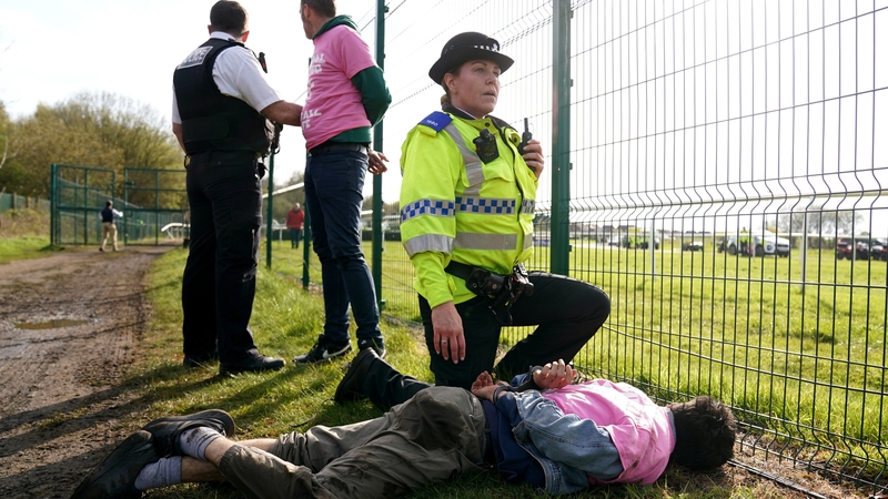 Protesters are detained by police at Aintree Racecourse, Liverpool