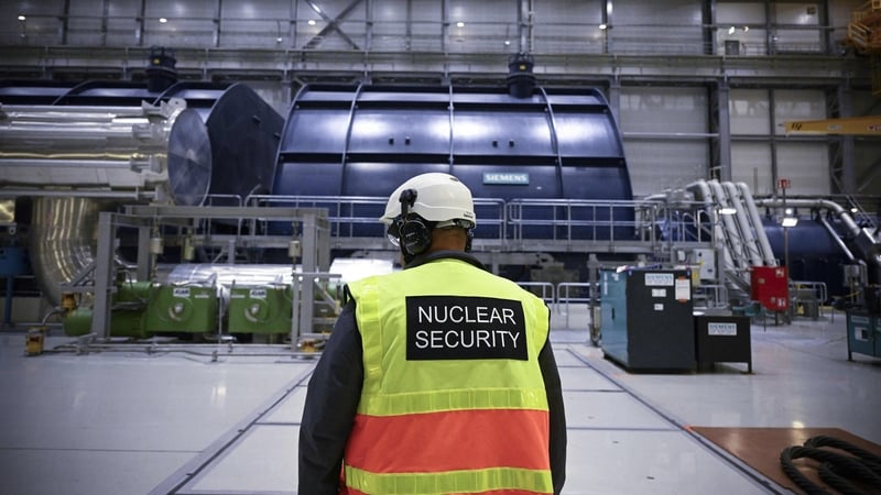 A security agent inspects the turbine room linked to the OL3 at the Olkiluoto nuclear power plant