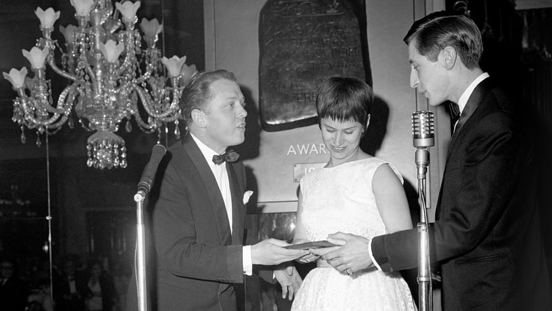 The Best British Dramatic Screenplay in 1961, given to Shelagh Delaney and Tony Richardson for the film A Taste of Honey, being accepted on their behalf by Rita Tushingham and Murray Melvin from Richard Attenborough (left)