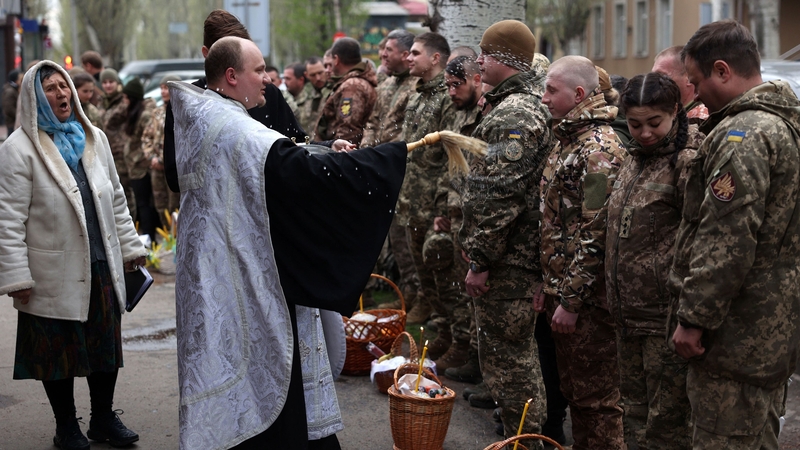 A priest blesses Ukrainian soldiers during a church service on the eve of the Orthodox Easter