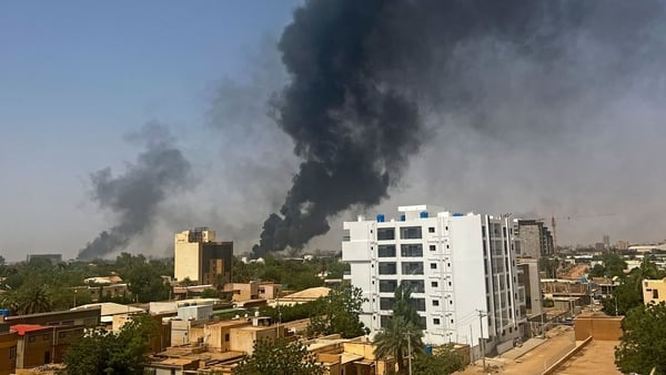 Smoke billows above residential buildings in Khartoum as fighting in Sudan raged for a second day