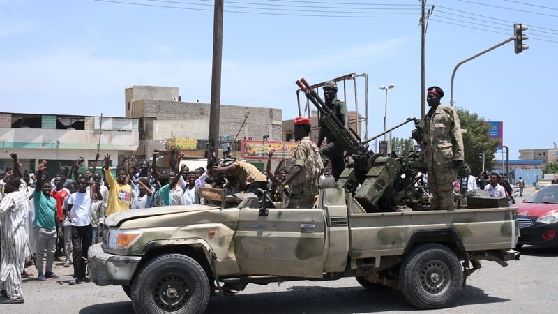 People greet soldiers loyal to army chief Abdel Fattah al-Burhan in the Red Sea city of Port Sudan