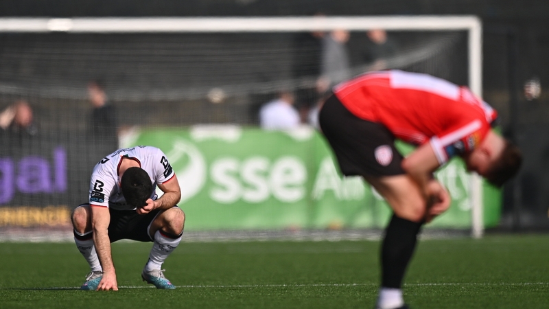 Patrick Hoban of Dundalk, left, and Will Patching of Derry City react at the final whistle on Sunday