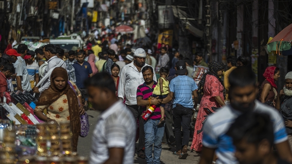 People walk through the Sadar Bazaar in New Delhi, India